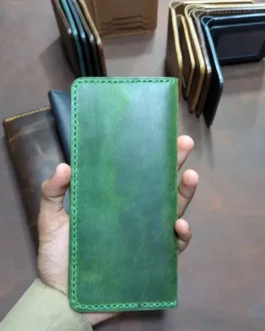 Closed front view of a handcrafted green leather long bifold wallet with green stitching.